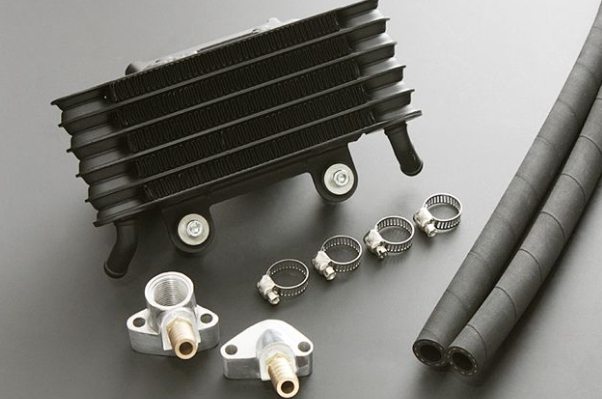 Car radiator components including a core, pipes, and connectors on a gray background