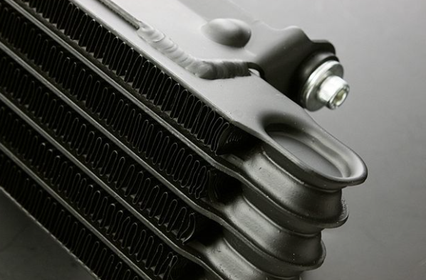 Close-up of a car radiator on a gray background
