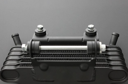 Black metal heat exchanger on a gray background