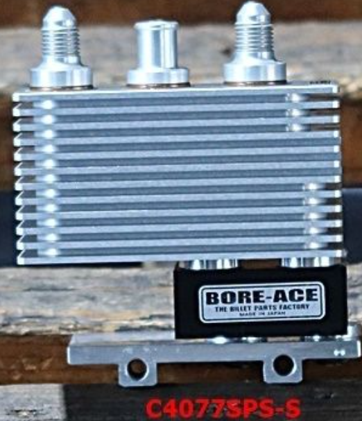 Metallic oil cooler with 'Bore-Ace' branding on a wooden surface