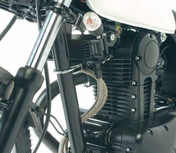 Close-up of a motorcycle engine and suspension system on a white background