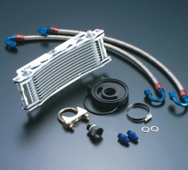 Oil cooler kit with hoses, clamps, and connectors on a dark background