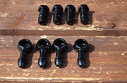 Set of black screws on a wooden surface