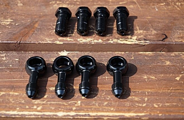 Set of black screws on a wooden surface