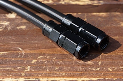 Black metal connectors on a wooden surface