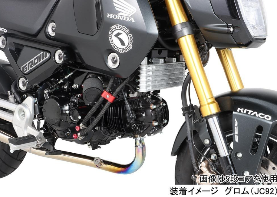Close-up of a Honda motorcycle engine with visible branding on a white background