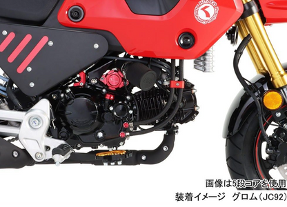 Close-up of a motorcycle engine and frame with visible branding on a white background