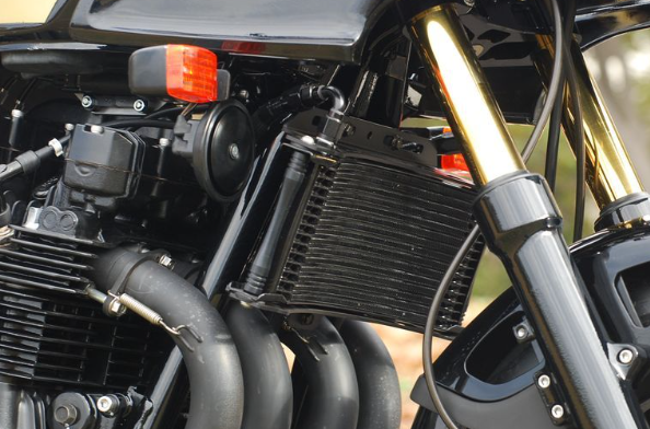Close-up of a motorcycle engine and exhaust system with a blurred background