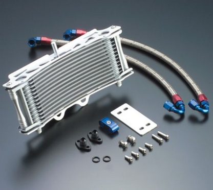 Oil cooler with hoses and mounting hardware on a gray background