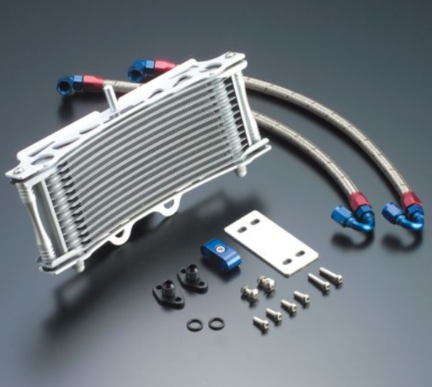 Oil cooler with hoses and mounting hardware on a gray background
