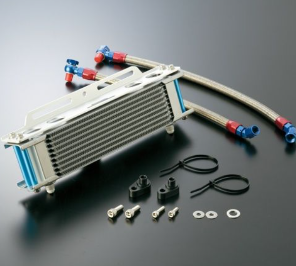 Oil cooler assembly with hoses and mounting hardware on a dark background