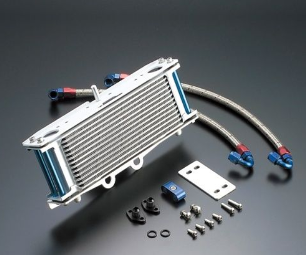 Oil cooler with hoses and mounting hardware on a gray background