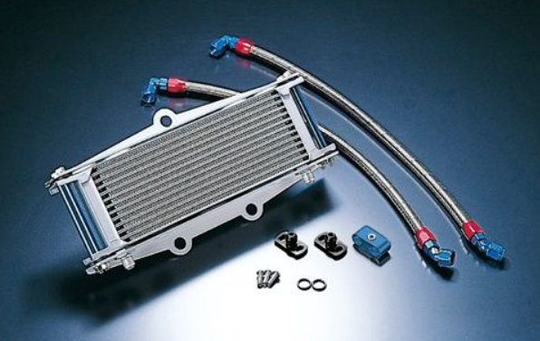 Metallic radiator with hoses and connectors on a reflective surface
