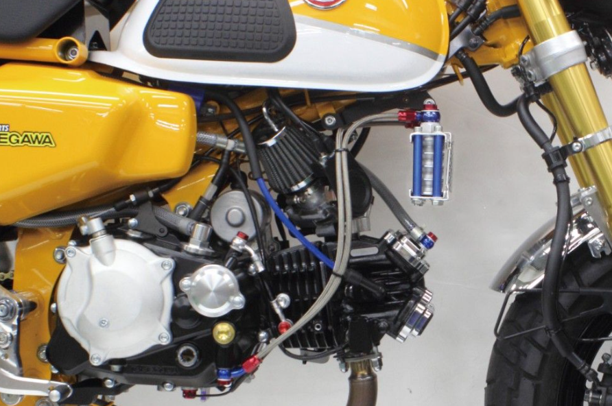 Close-up of a motorcycle engine with visible branding on a white background
