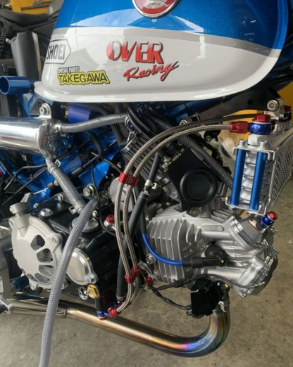 Close-up of a motorcycle engine with visible branding on a concrete surface