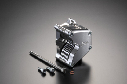 Metallic engine block with components on a gray background