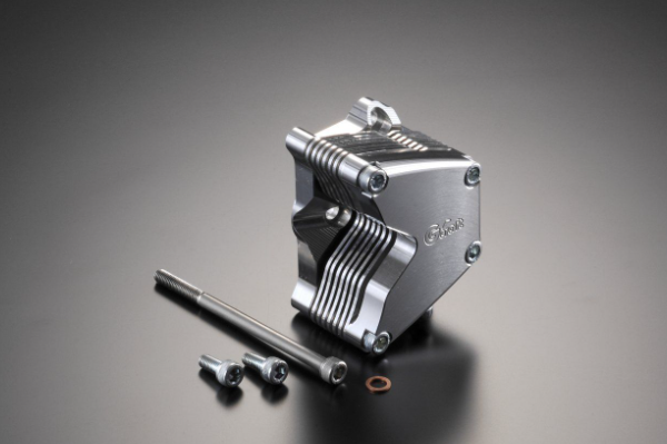 Metallic engine block with components on a gray background