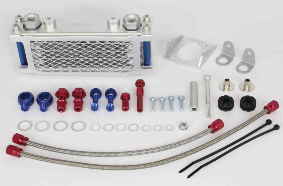 Collection of automotive parts including a silver radiator, hoses, and connectors on a white background