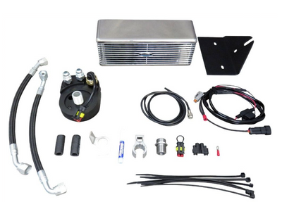 Collection of automotive parts including an oil cooler, hoses, and connectors on a white background