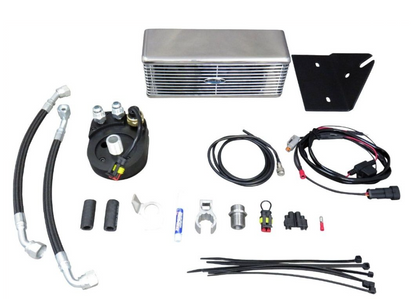 Collection of automotive parts including an oil cooler, hoses, and connectors on a white background