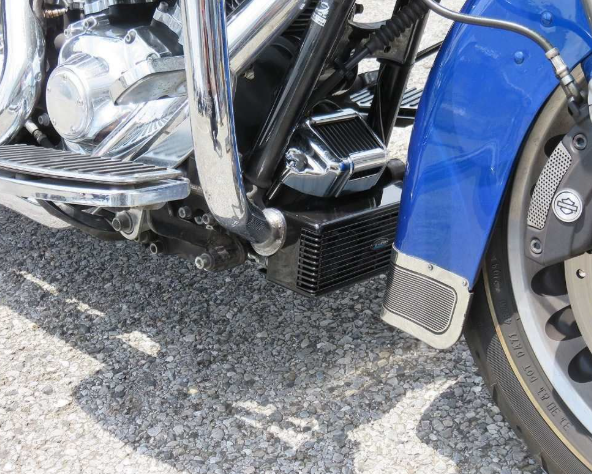 Close-up of a blue motorcycle with visible branding on a textured surface