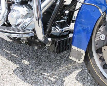 Close-up of a blue motorcycle with visible branding on a textured surface