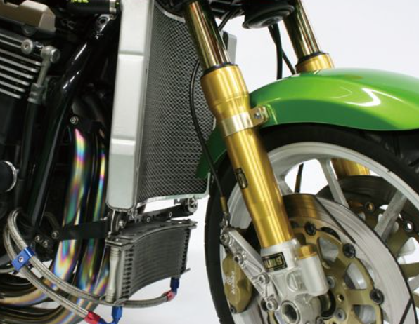Close-up of a motorcycle's suspension and engine on a white background