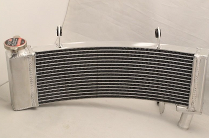 Curved metal radiator on a white background