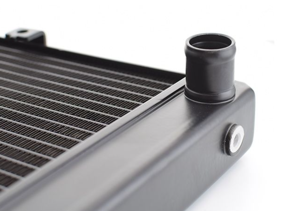 Close-up of a radiator with a black plastic cap on a white background