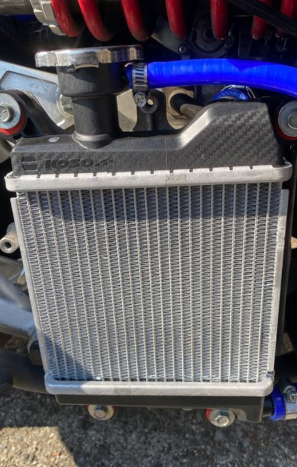 Motorcycle radiator with visible branding on a blurred background