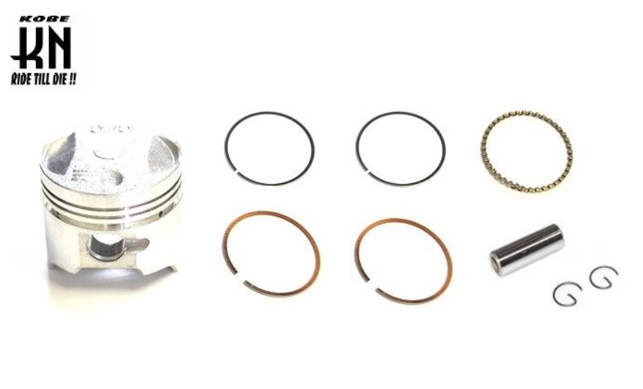 Engine piston and rings set with KOBE branding on a white background