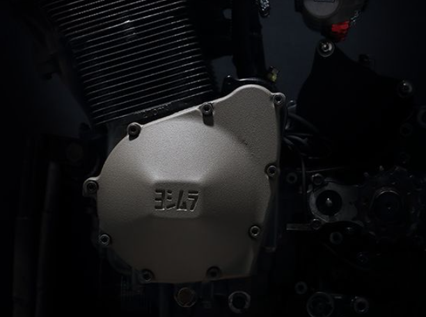 Close-up of a motorcycle engine cover with 'Bullitt' branding on a dark background
