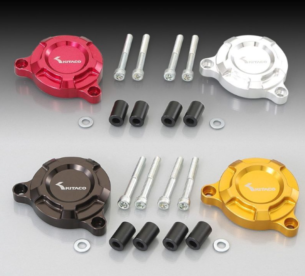 Set of KTM motorcycle parts including red, silver, brown, and gold covers with bolts and washers on a gray background.