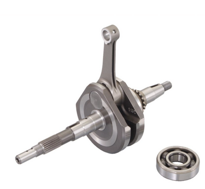 Metallic crankshaft with a bearing on a white background