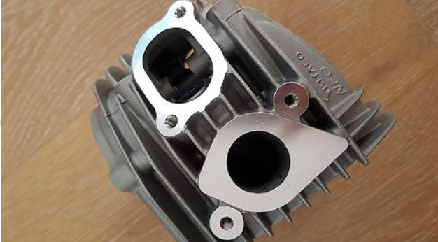 Close-up of a mechanical engine component on a wooden surface