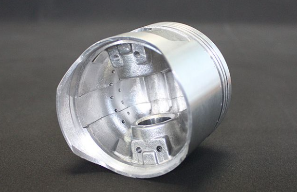 Metallic cylindrical component on a dark background