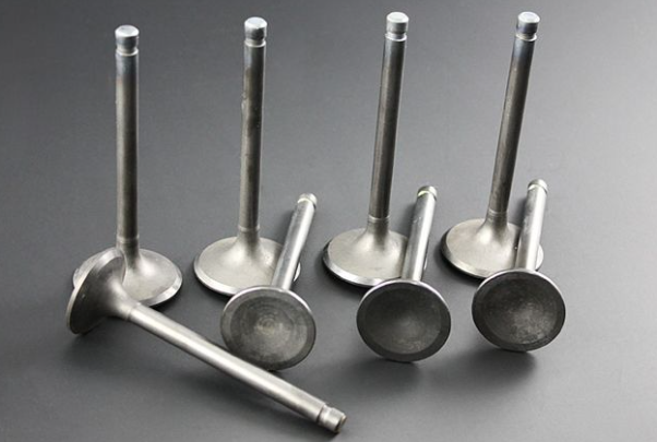 Set of metal valve components on a gray background