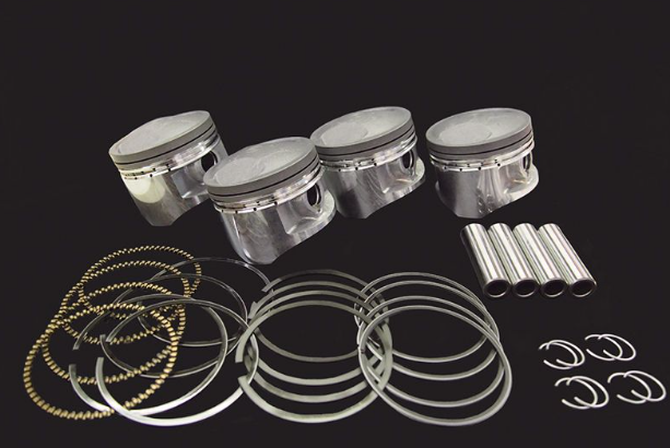 Set of piston rings and pins on a black background