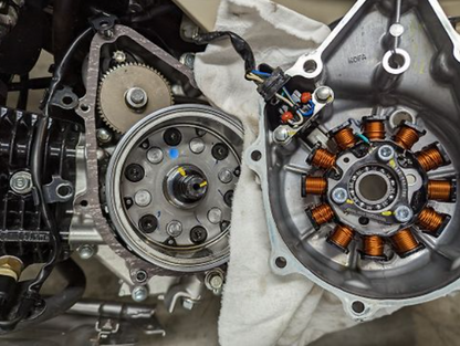 Close-up of mechanical components, likely from a vehicle or machinery, with gears and wiring.