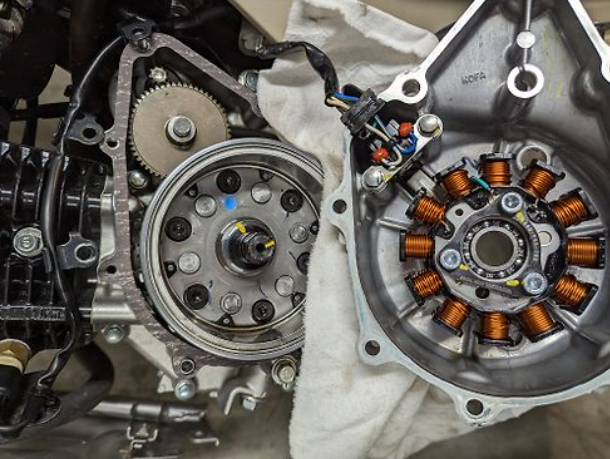 Close-up of mechanical components, likely from a vehicle or machinery, with gears and wiring.