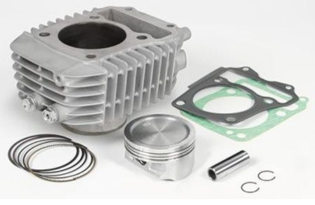 Engine cylinder head with piston, rings, and gaskets on a white background