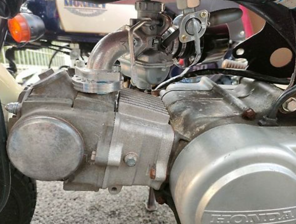 Close-up of a motorcycle engine with visible branding