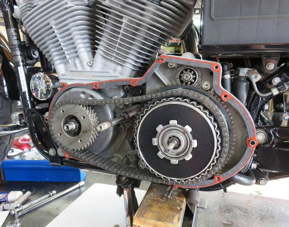 Close-up of a motorcycle engine with gears and belts