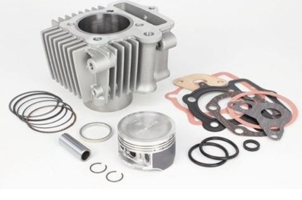 Engine parts including a cylinder, piston, rings, and gaskets on a white background