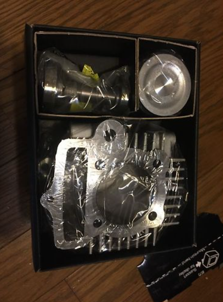 Mechanical parts in a box on a wooden surface