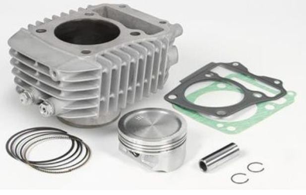 Engine cylinder head with gaskets, washers, and piston on a white background