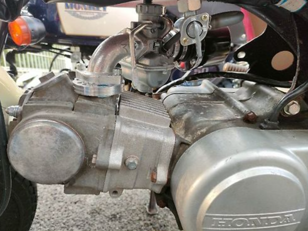 Close-up of a motorcycle engine with visible branding