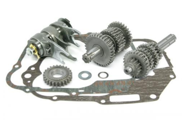 Mechanical gear set with various gears and a gasket on a white background