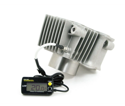 Metallic heat sink with digital thermometer on a white background