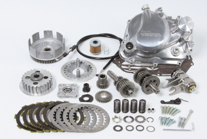 Collection of mechanical parts including gears and springs on a white background
